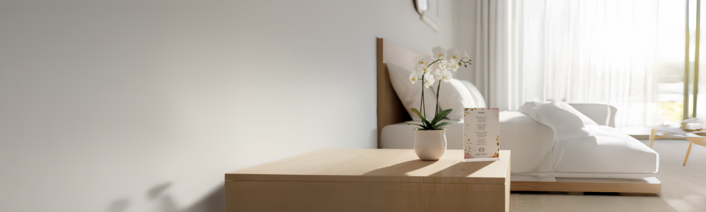 A white orchid in a planter sitting next to a poem on a table in a bedroom
